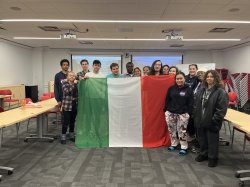 Mark Rotella and students at My Cousin Vinny Movie Night holding Italian flag