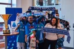 People holding soccer banners for Napoli