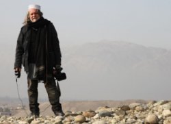 Photo of cameraman standing on rocks