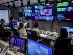 Photo of sudents in live TV production booth producing a show.