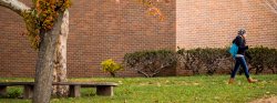 photo of student walking on campus
