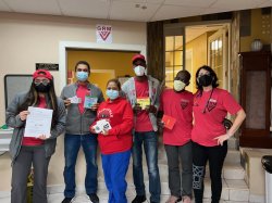 a group of people wearing masks stand side by side and pos for a photo