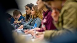 Students sitting in a row learning
