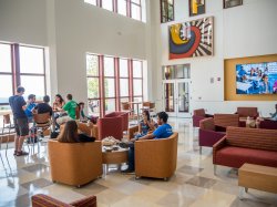 students seated and talking in common area
