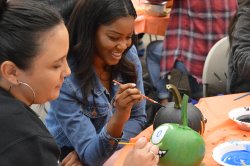 students painting pumpkins