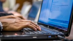 hands on laptop keyboard