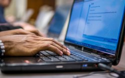 hands on laptop keyboard