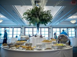 A custom centerpiece and a variety of food from an event in the Main Ballroom at the Conference Center.