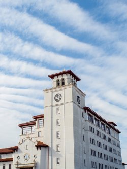 The exterior of University Hall's bell tower against a blue sky.