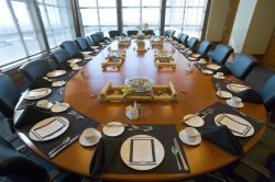 The President's Dining Room set up for dinner with place-settings and a menu at the Conference Center in University Hall.