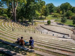 two students sitting at the top of the amphitheater