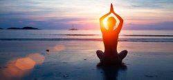 person meditating on the beach
