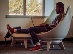 Student sitting in chair using laptop