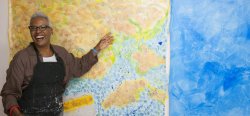 Nell Painter presenting artwork in blue and yellow