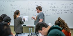 students taking notes by whiteboard