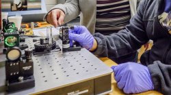 student working with gravitational wave detection equipment