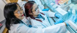 student and professor in water testing lab