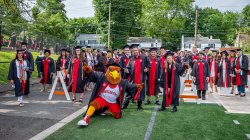 CSAM graduates at their commencement ceremony with Rocky