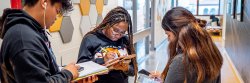 students reviewing together in hallway