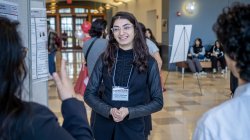 Melissa Spigelman talking with colleagues during the Casabona Competition Poster session