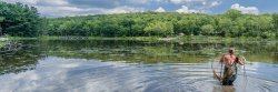 student in lake collecting samples