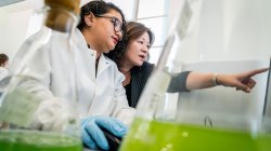 PhD student analyzing data with advisor