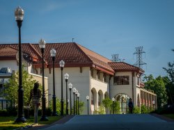 A student walking by the School of Communication and Media and Life Hall.
