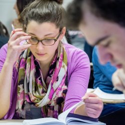 Close up of a student reading in a poetry class.