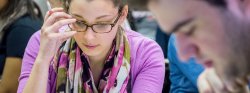 Close up of a student reading in a poetry class.