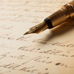 Image of a fountain pen with a manuscript.