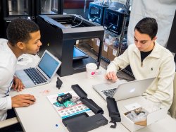 Two students at laptops inside MIX Lab
