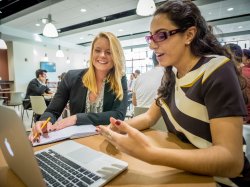 Two female students at a laptop