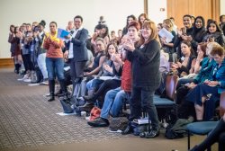 Attendees in the crowd, applauding