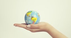 female hand holding globe