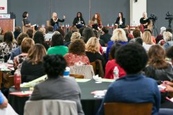Audience watching panel of women