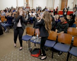 Two women look shocked, reacting to winning pitch contest.