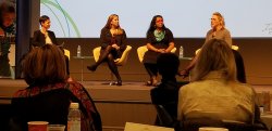 Four women on stage for panel