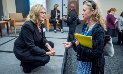 Panelist Tracy Doyle speaks to an attendee after the event