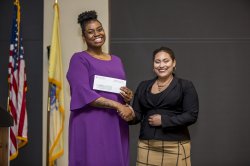 Alicia-Ann Caesar receiving award from Olivia Hettman