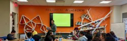Students in classroom with strange bookshelf