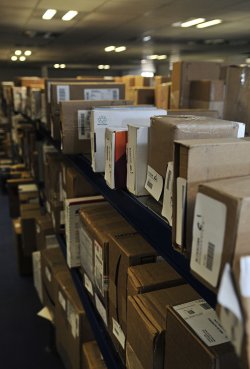 Packages on shelves awaiting delivery.