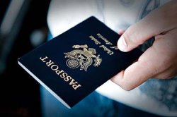 Close-up of hand holding passport.