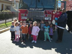 Students stand infront of a Little Falls Fire Department ladder truck.