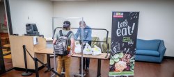Student picking up an order from dining services that was placed through Grub Hub.