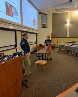 An image of fire safety personnel demonstrating the use of a fire extinguisher