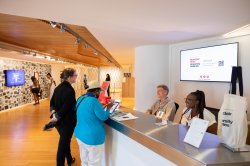 Visitors check in at the front desk of the Segal Gallery.