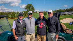 Four men standing on golf course