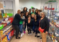 Team of volunteers pose for photo in pantry