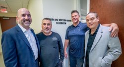group of men in front of sign
