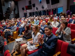 Theatre full of attendees.